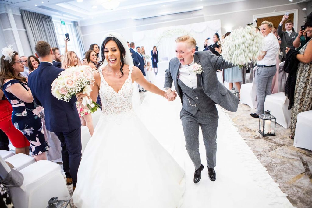 Newlyweds walking down the aisle in style at the Arden Suite