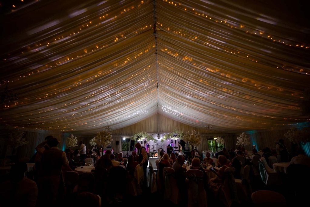 A photo of the marquee at Forest of Arden with dancefloor and people dancing at a wedding
